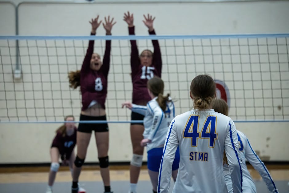 Players in action during a high school volleyball match in Rochester, MN.