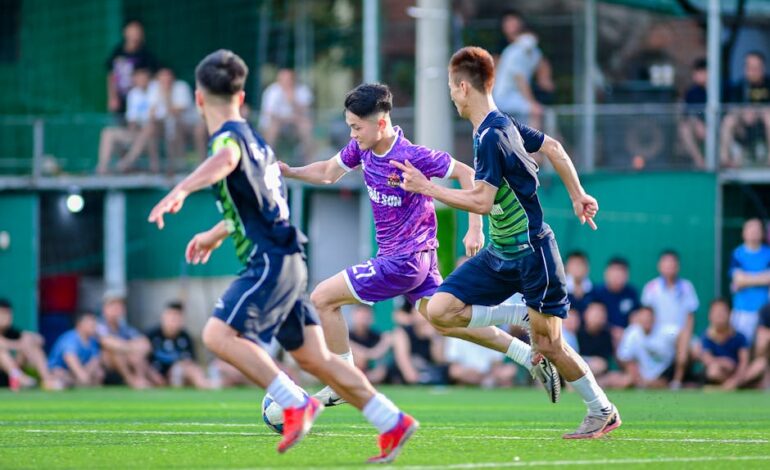 Dynamic action shot of a youth soccer game in Hà Nội, capturing players competing for the ball.
