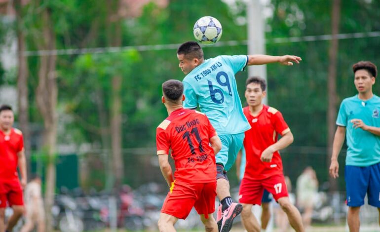Players in action during a soccer match in Hà Nội, capturing dynamic movement.