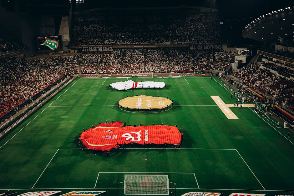 Aerial shot of a football match in Abu Dhabi stadium filled with enthusiastic fans.