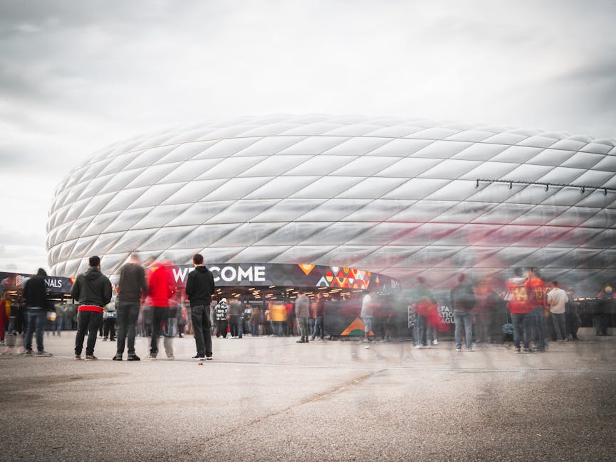 Fans gathering outside Allianz Arena in Munich, Germany, ready for a soccer event.