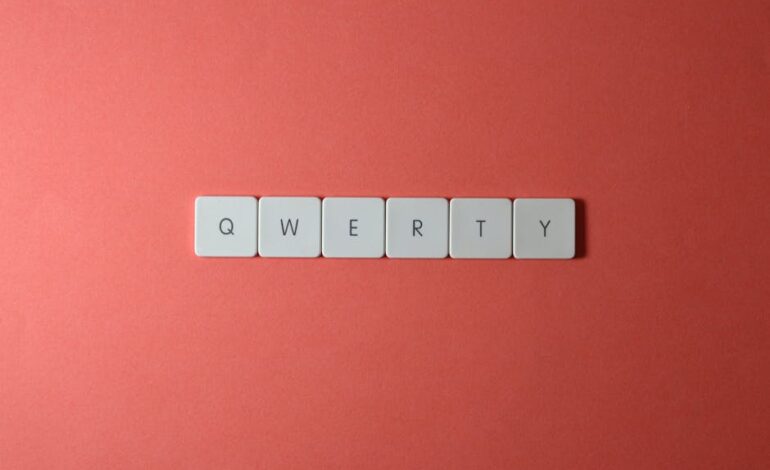 Minimalist display of QWERTY keys arranged on a vibrant red surface, ideal for technology and design concepts.
