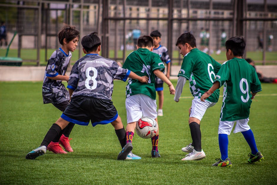 Young soccer players engaging in a dynamic football training session on a Chilean field.