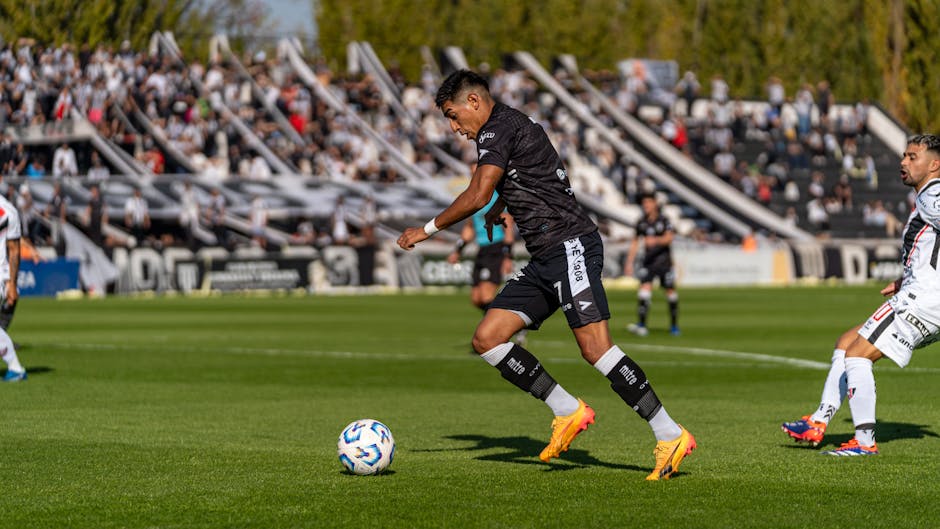 Exciting football match capturing players in action, showcasing athleticism and teamwork.