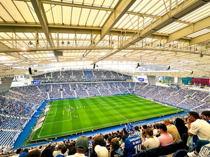 A lively football match underway at Porto's iconic Estádio do Dragão, packed with enthusiastic fans.