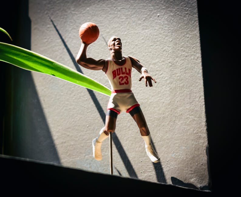 Dynamic figurine of a basketball player in Bulls jersey jumping with a ball in hand.