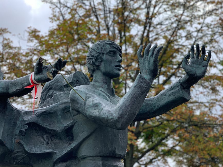 A striking bronze sculpture in Minsk park during fall, showcasing artistic detail.
