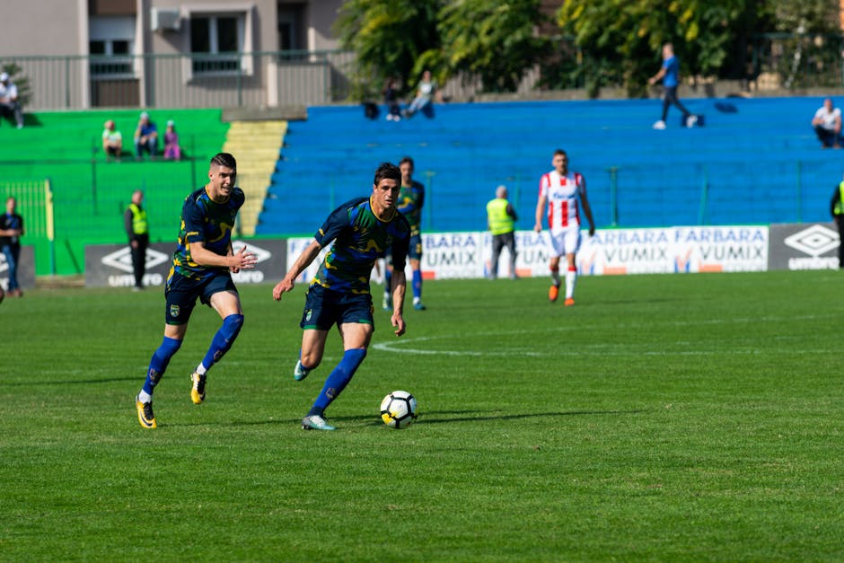 Dynamic soccer match with players in action on the field, highlighting teamwork and competition.
