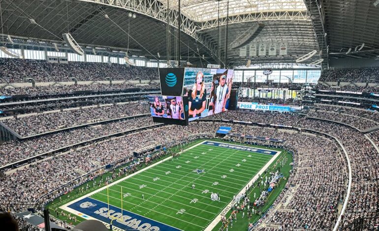 A packed AT&T Stadium in Arlington, Texas, showcasing a thrilling football game with enthusiastic fans.