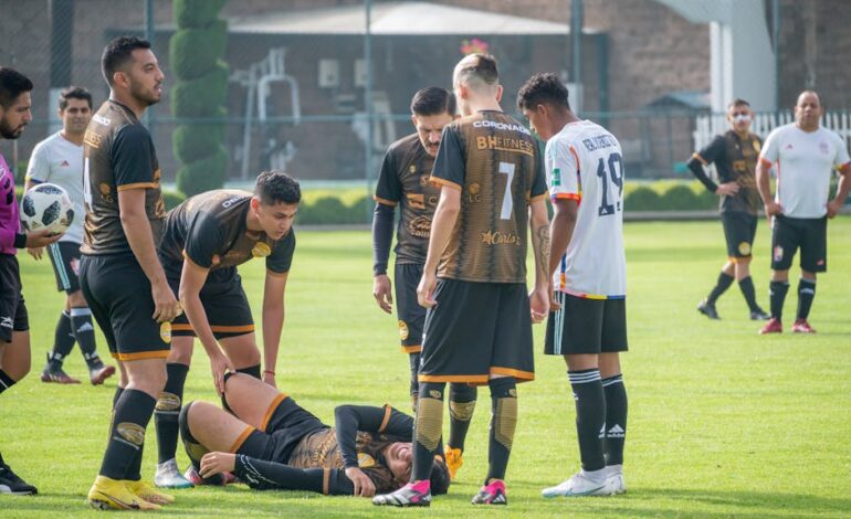 Players gather around an injured teammate during a soccer match in Texcoco, Mexico.