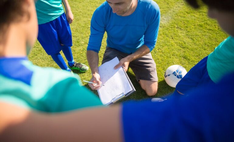 Coach instructing young soccer players during a practice session in Portugal.
