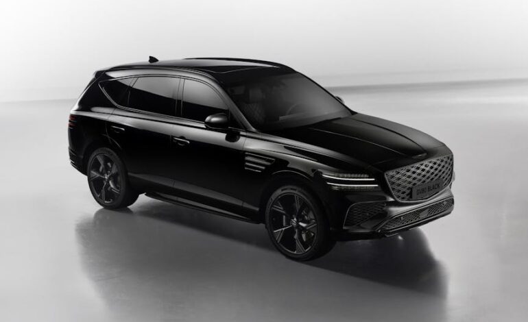 Luxurious black SUV pictured in sleek studio lighting, showcasing modern design.