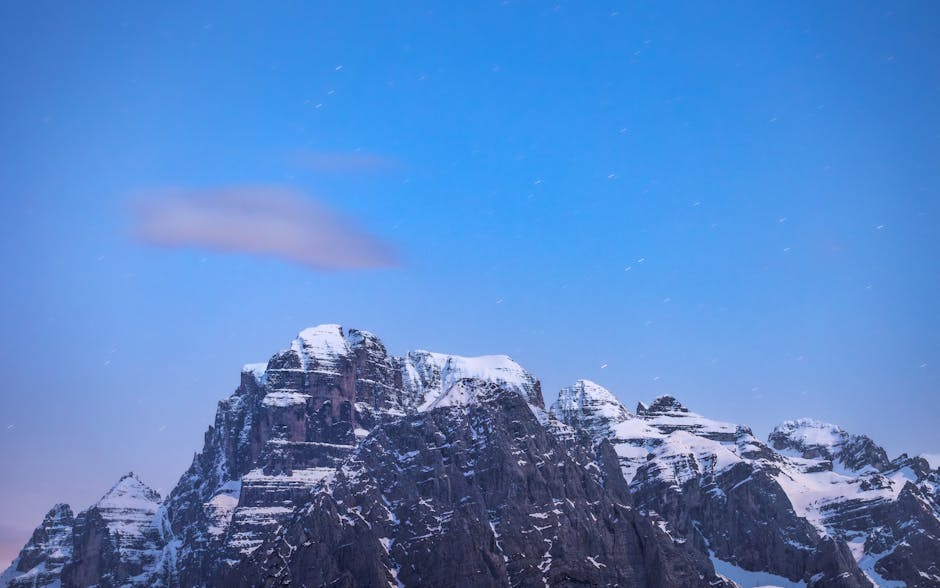 Captivating view of the snowy Alps under a clear, starry night sky. Perfect for adventure and nature enthusiasts.