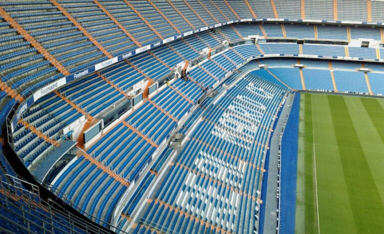 Aerial view of an empty stadium seating area in Madrid, showcasing a modern architectural design.