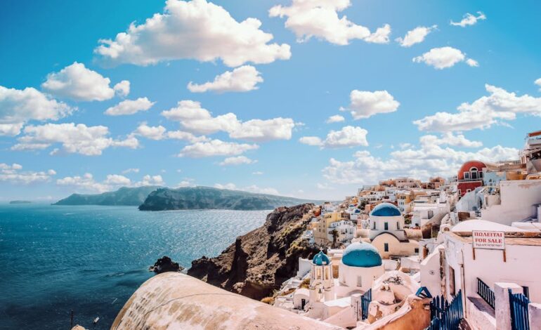 Captivating view of Santorini's famous blue-domed buildings under a vibrant sky.