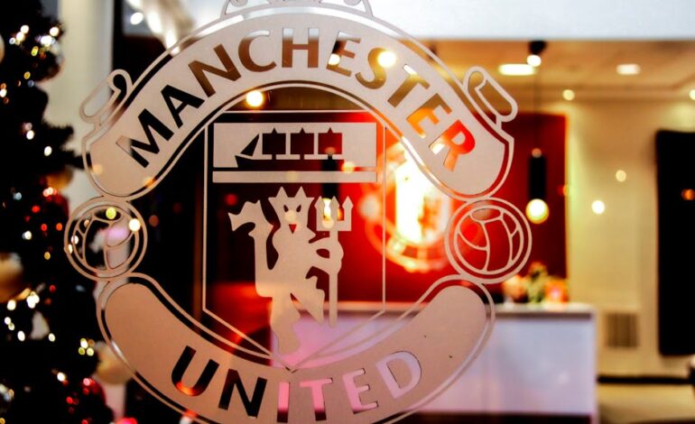 Close-up of Manchester United emblem etched on glass, showcasing iconic design indoors.