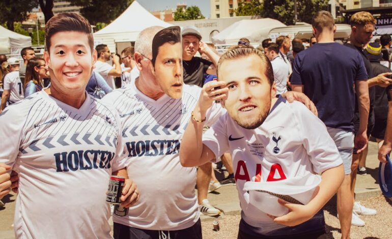Group of soccer fans donning team jerseys and masks at an outdoor event in Madrid.
