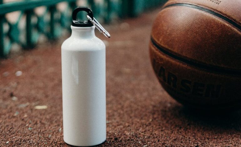 White water bottle and basketball on outdoor sports court.