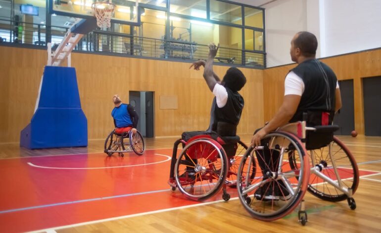 Wheelchair basketball players engaged in a competitive game indoors.