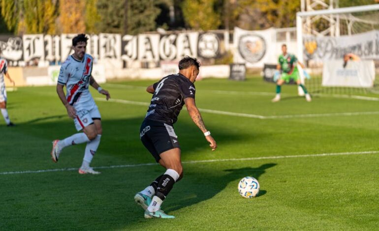 Players in action during an outdoor soccer game on a sunny day, highlighting sportsmanship.