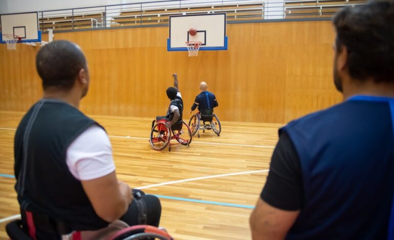 Players in wheelchairs enjoying a competitive basketball game on an indoor court.