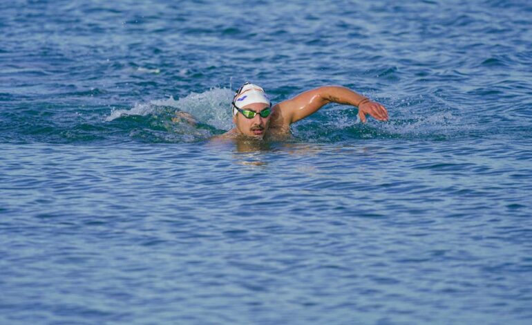 Athlete swimming freestyle in the clear waters of Kuşadası, Türkiye.
