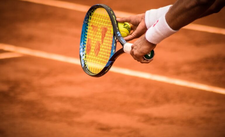 Close-up of a tennis player preparing to serve on a clay court in Montevideo.