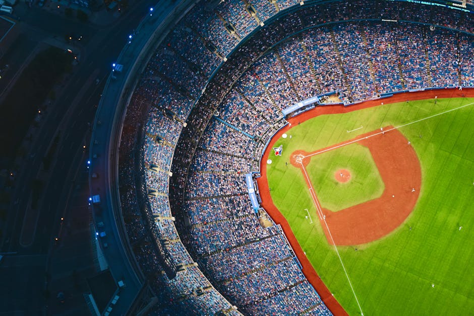 High-angle view of a crowded baseball stadium with green field in Toronto during a game.