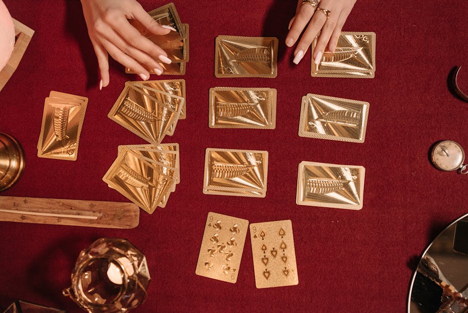 Hands deal shiny gold tarot cards on rich red velvet, creating a mystical atmosphere.