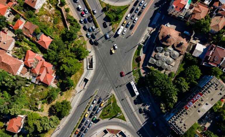 Drone shot capturing a busy intersection in Plovdiv, showcasing roads, cars, and urban architecture.