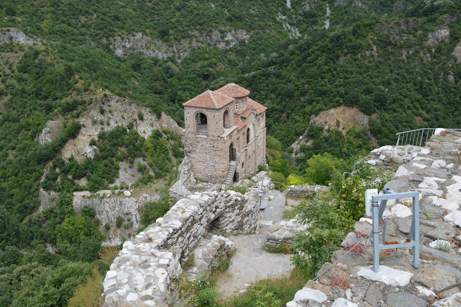 Explore the historic Asen's Fortress in Assenovgrad, Bulgaria, captured from above amidst lush greenery.