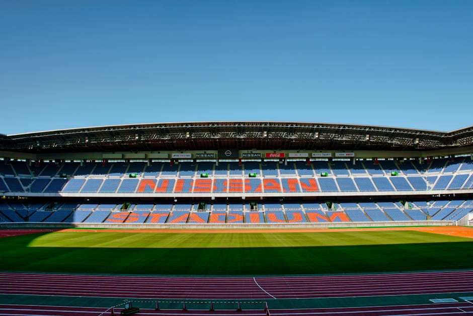 Wide-angle shot of the empty Nissan Stadium in Yokohama, featuring clear blue skies.