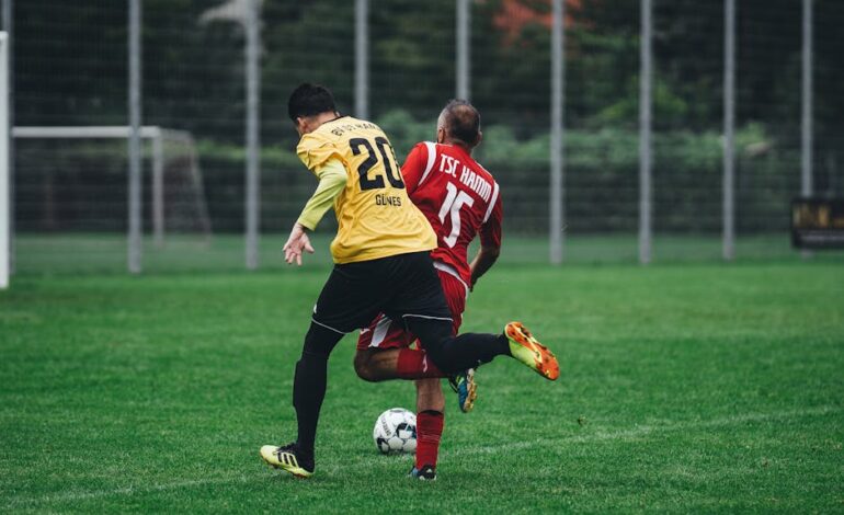 Two soccer players in action on a vibrant green field during a daytime match.