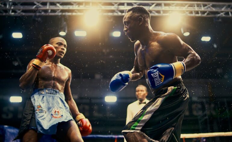 Two boxers in an intense match inside a well-lit arena in Lagos, Nigeria, showcasing athletic power and strategy.