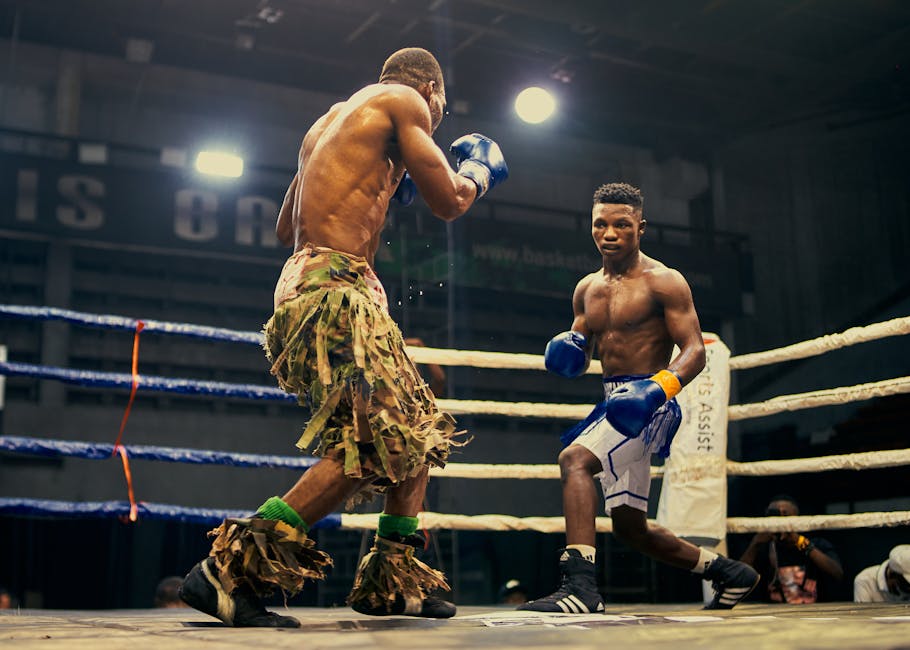 Two boxers engaged in a thrilling fight in a Lagos boxing ring.