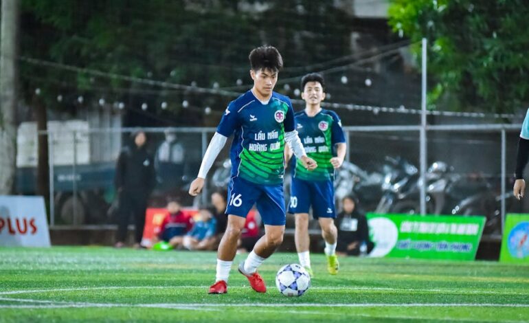 Energetic football match capturing teamwork and skill in Hanoi, Vietnam.