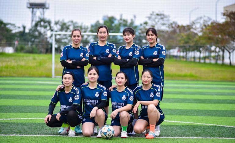 A women's soccer team posing proudly on an outdoor field in Hà Nội, Vietnam.