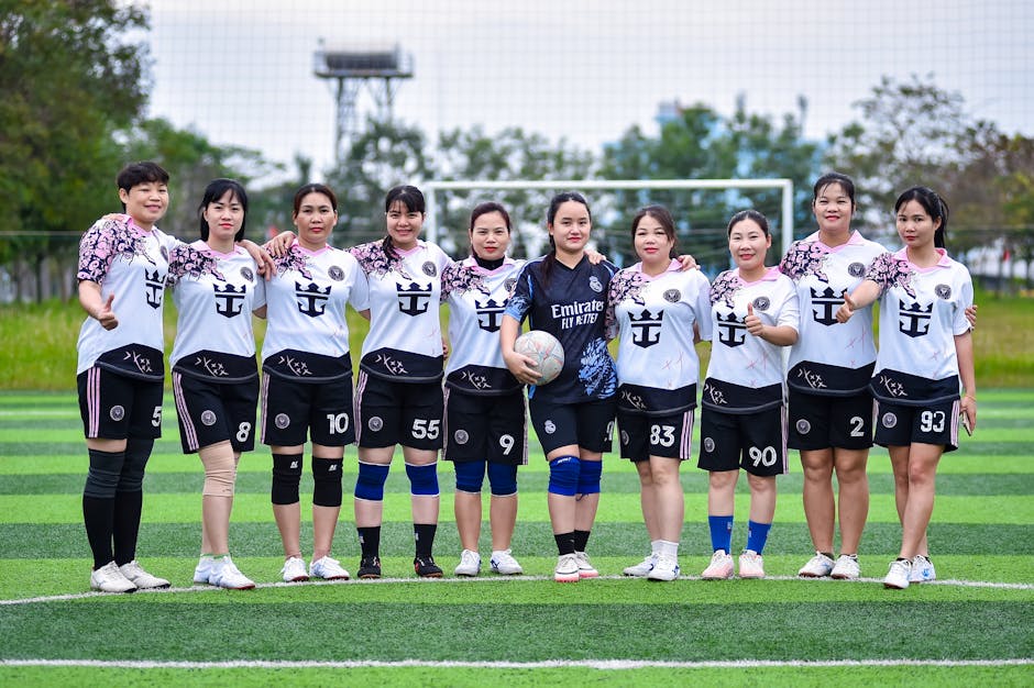 Group of women football players posing on a field in Hanoi, capturing team spirit and camaraderie.