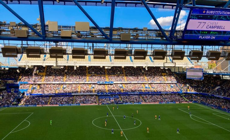 A lively football match in Stamford, England capturing the crowd and players in a filled stadium.