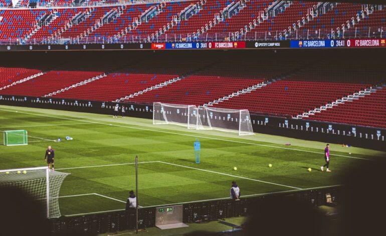 View of empty soccer field at FC Barcelona's Camp Nou with training equipment.