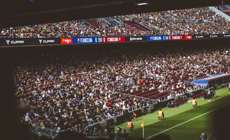 Packed stadium with spectators at an FC Barcelona soccer match, vibrant atmosphere.