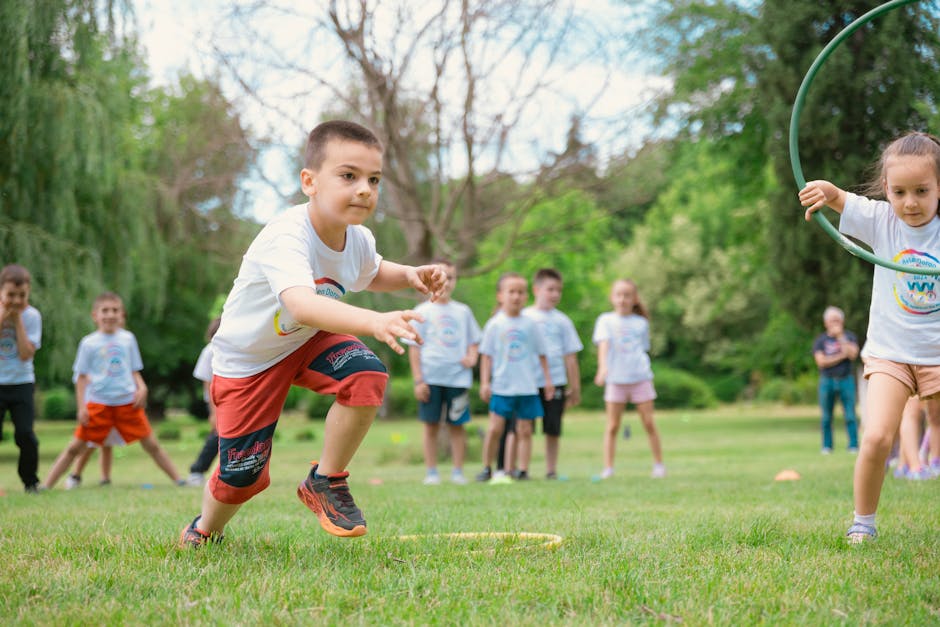 A group of children actively playing with hula hoops on a bright summer day in the park.