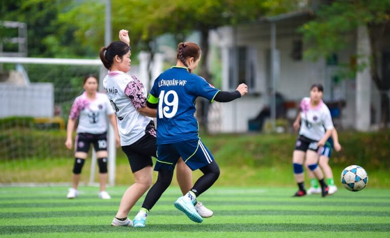 Exciting women's football action capturing team spirit on a vibrant field in Hà Nội, Vietnam.