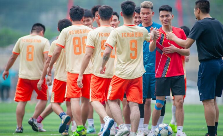A local soccer team greeting opponents on a sunny day in Hà Nội, Vietnam.