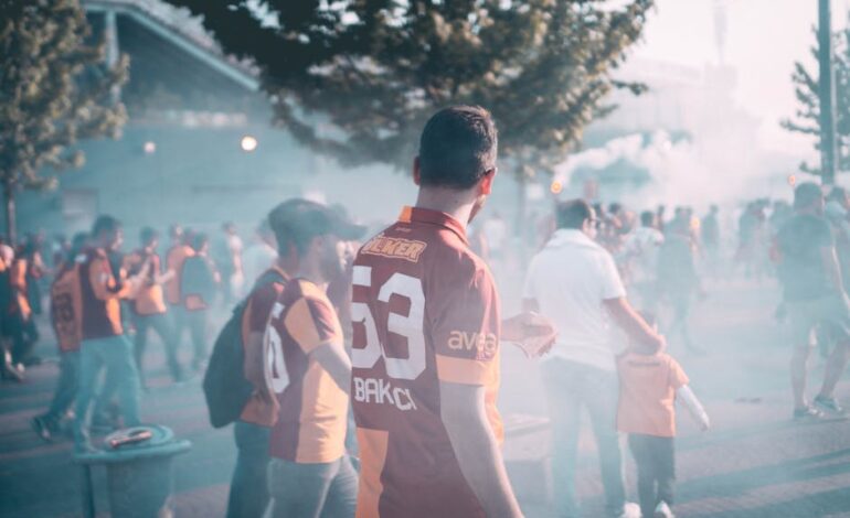 Crowd of enthusiastic football fans gathering outside a stadium in İstanbul, Türkiye.