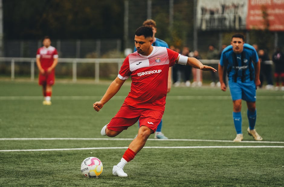 Football player in action on the pitch, showcasing athletic skill.