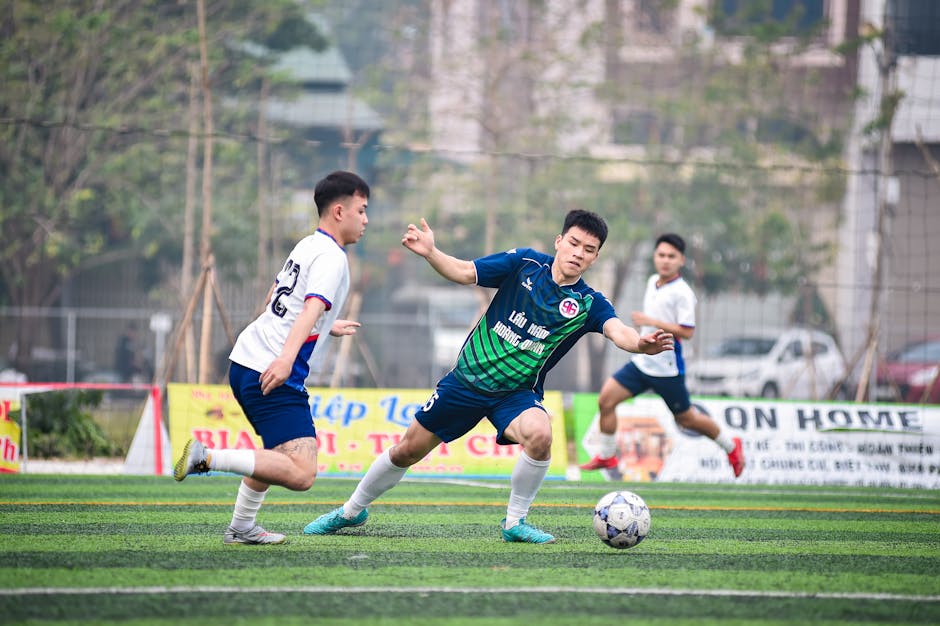 Dynamic soccer scene with players in action during a match in Hà Nội, Vietnam.