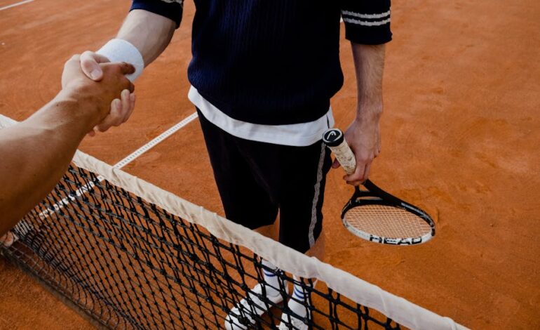 A close-up of tennis players shaking hands over the net on a clay court.
