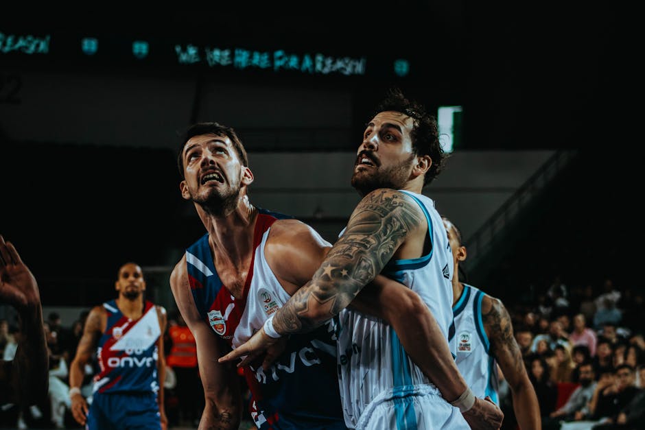 Two male basketball players in action during an intense game. Competitive sports photography.
