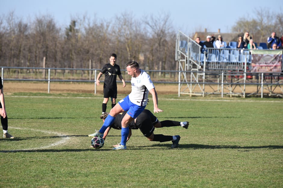 Players in action during a local soccer match in Vásárosnamény, Hungary, showcasing intense athletic competition.
